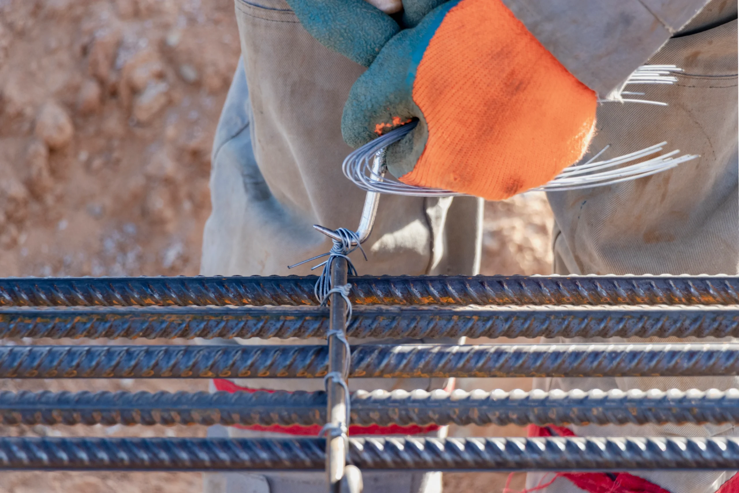 worker-uses-steel-tying-wire-fasten-steel-rods-reinforcement-bars-closeup-reinforced-concrete-structures-knitting-metal-reinforcing-cage (1)